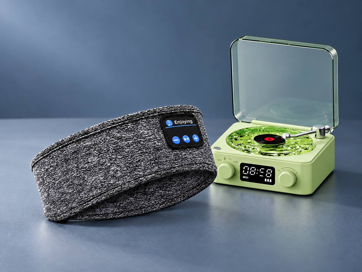 Grey Bluetooth headband and compact green speaker on a blue-grey background